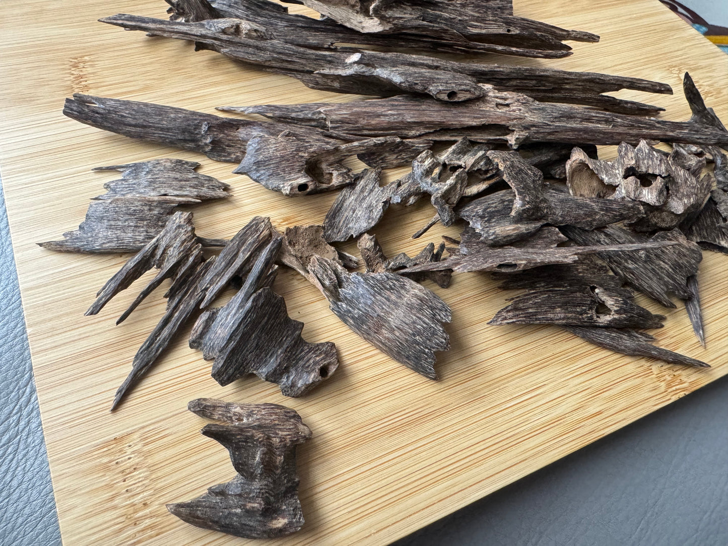 Wild Hindi Agarwood chips on a wooden table