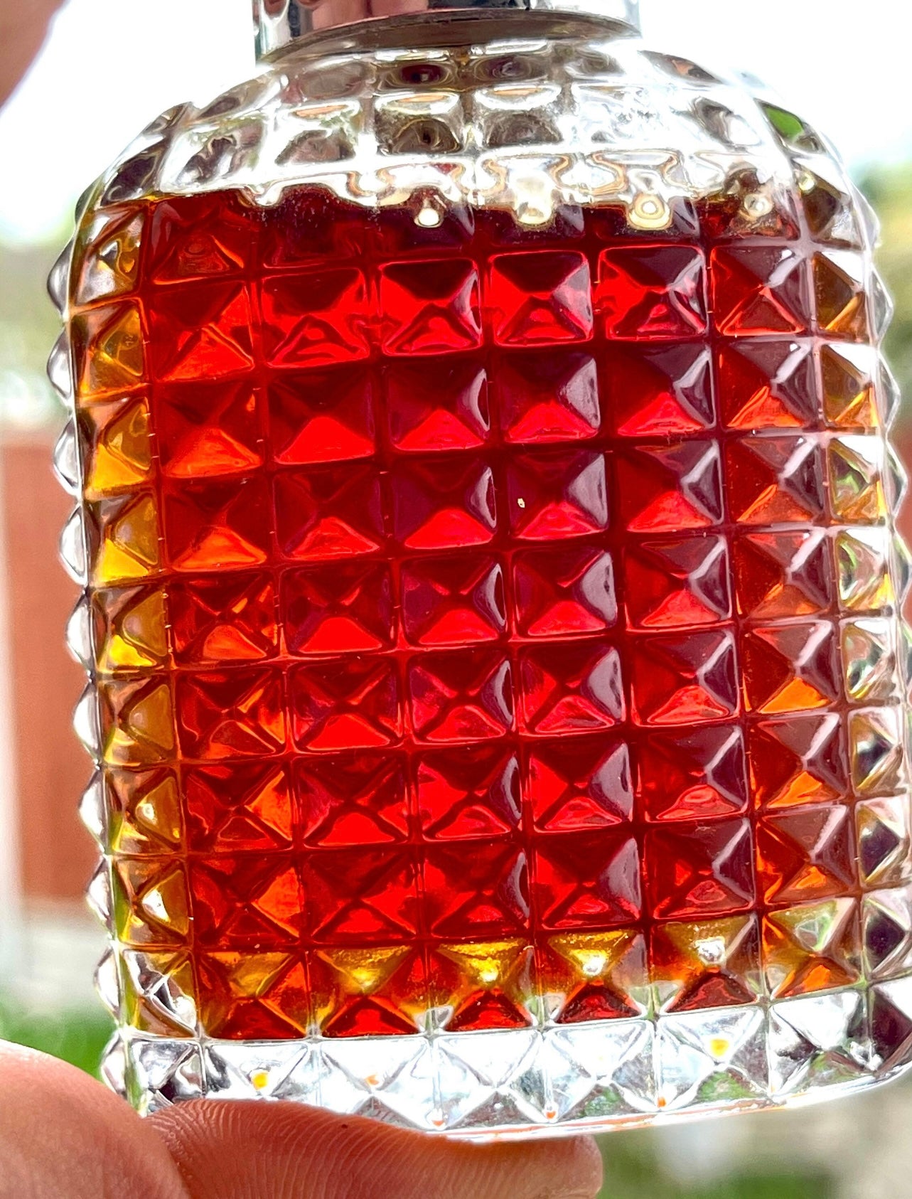 Man holding a bottle of vintage Sumba Indonesian sandalwood oil