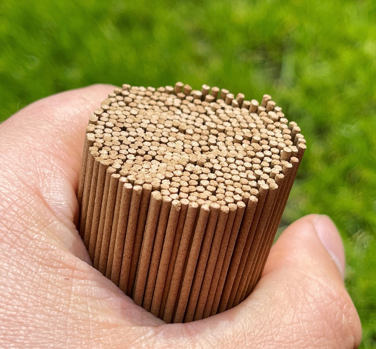 Man, holding large amount of artisan Agarwood incense sticks