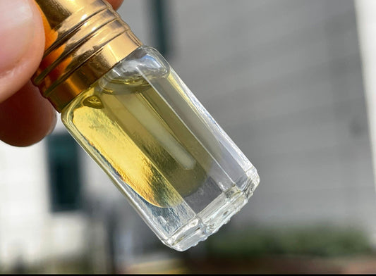 Man holding a bottle of a Indian Sandalwood essential oil