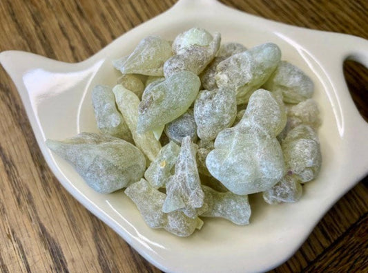 Close up of Royal Green Hojari frankincense pieces on a plate on a table