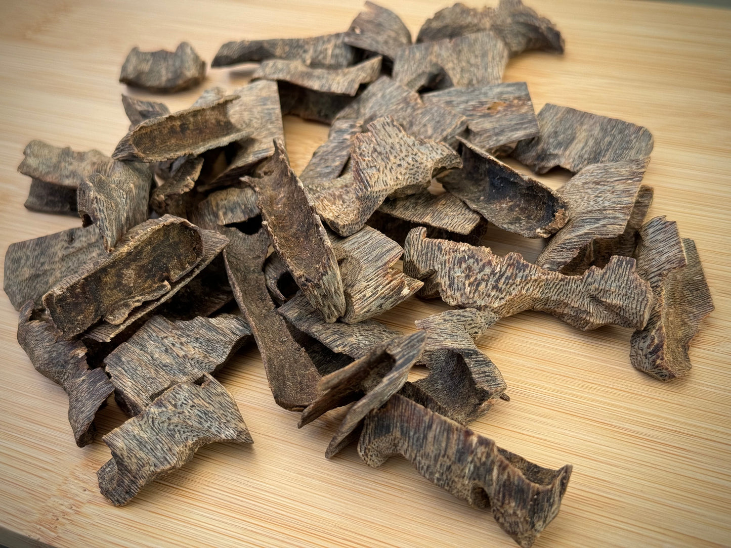 Close-up of sinking Hainan cultivated Kinam Agarwood chips