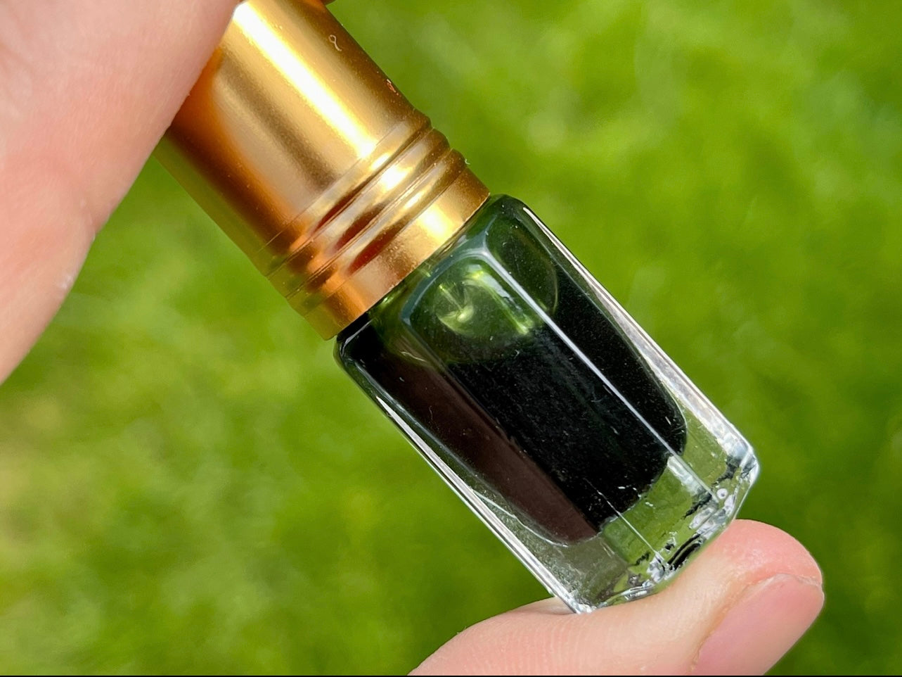 A man holding a bottle of vetiver essential oil