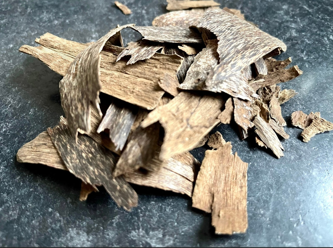 Trat Thailand Agarwood chips on a grey table