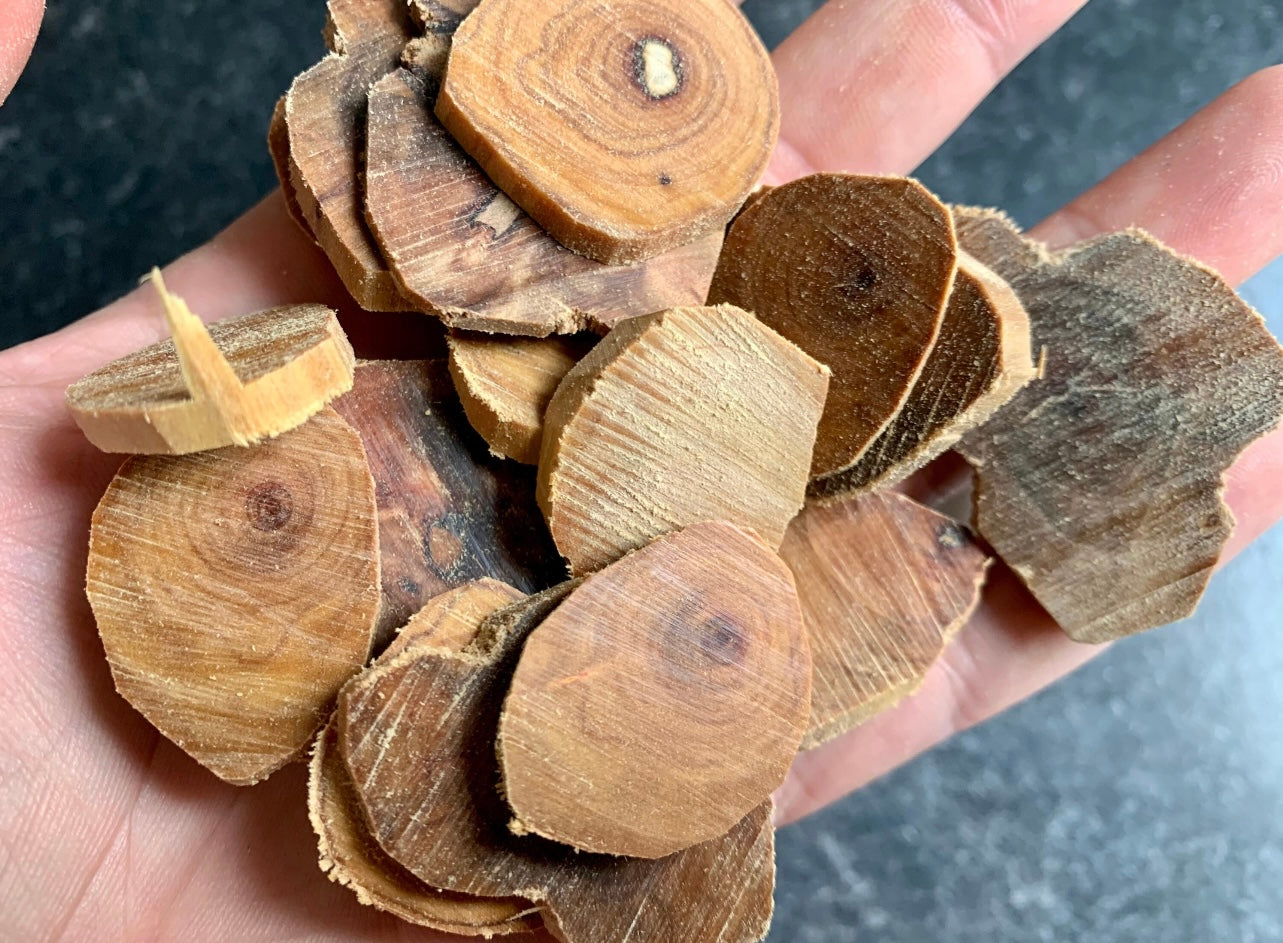 Man holding sinking grade Sandalwood pieces